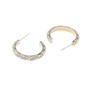 Golden twisted hoop earrings with turquoise bead accents in a minimalist C-shape design