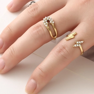 French style gold lightning and safety pin rings set with elegant pearl accents