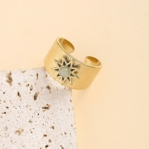 Gold wide band ring with vertical texture, sunburst motif and green stone inlay
