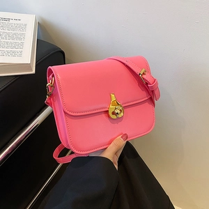 Pink leather mini crossbody square bag with gold drop clasp and adjustable strap