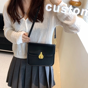 Chic black glossy leather square shoulder bag with gold pear-shaped twist lock