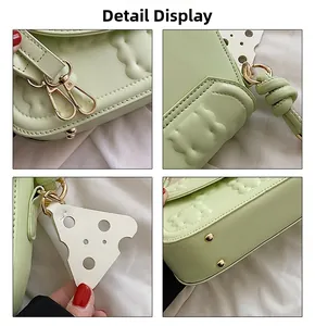 Detail display of mint green textured leather bag with cheese pattern and gold hardware