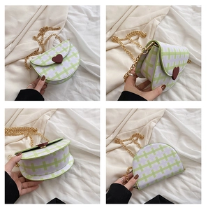 Detailed four-angle views of a plaid saddle bag with heart charm and gold chain strap