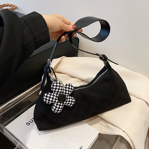 Minimalist black jacquard shoulder bag with checkered flower charm and adjustable strap