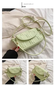 Detail of light green PU leather shoulder bag featuring 3D padded bear quilting pattern