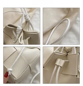 Detail view of woven leather bucket bag with drawstring closure and handle craftsmanship