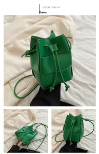 Detail view of the green woven texture and drawstring closure on the stylish bucket bag