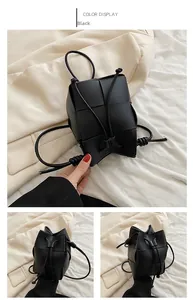 Detail of a black woven bucket bag showing premium matte texture and drawstring knots