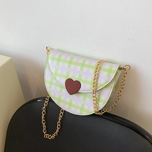 Summer plaid saddle bag with heart charm and golden chain strap on leather seat