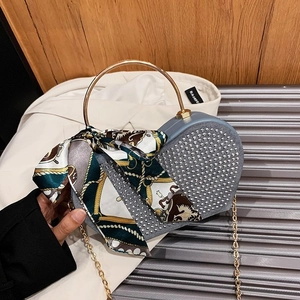 Blue heart-shaped evening bag with silver rhinestones and gold round metal handle