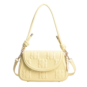 Pale yellow croissant shoulder bag with 3D embossed texture and gold hardware details