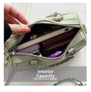 Detail showing internal capacity of the green barrel bag with silver chain strap