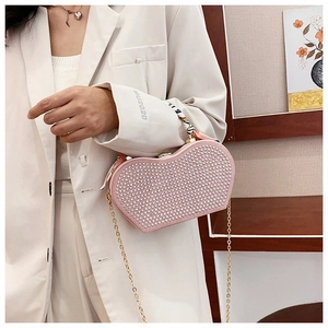 Pink heart-shaped evening bag with pearls, rhinestones, and scarf-wrapped handle