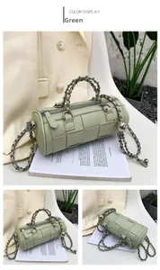 Detailed view of green woven leather cylinder bag with chunky chain shoulder strap