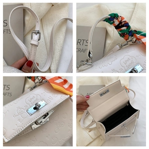 Detail shots of white embossed leather bag with floral scarf handle and metal lock
