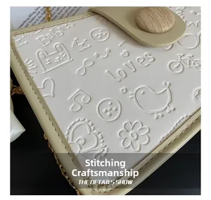 Detail showing high-quality stitching and embossed pattern on the mini crossbody bag