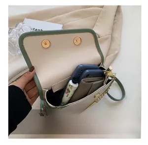 Internal view of bicolor saddle bag showing capacity for phones and wallet
