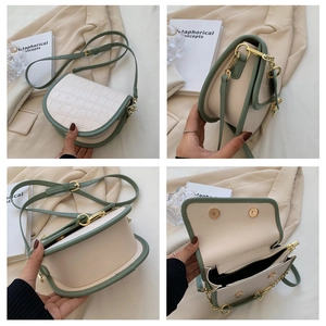 Detail view of contrast saddle bag showing crocodile texture and internal structure