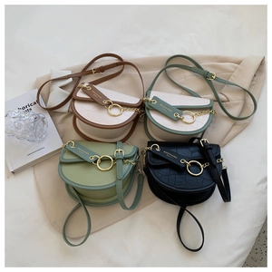 Top view of saddle bags in four colors with croc-effect texture and gold ring hardware