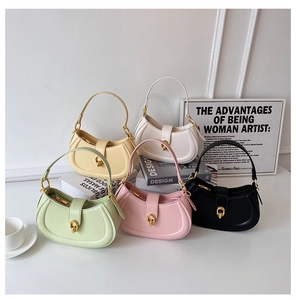Close-up of saddle hobo bags showing smooth leather texture and golden ring buckle detail