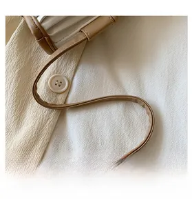 Detail of comfortable brown leather shoulder strap with fine stitching on a bag