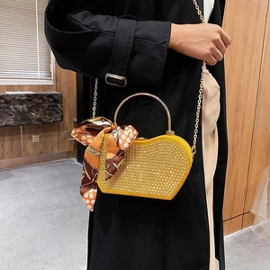Fashionable bright yellow heart-shaped handbag with rhinestones and gold chain strap