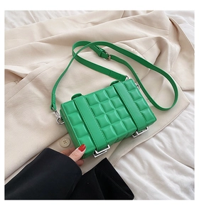 Detailed close-up of bright green quilted PU leather crossbody bag with silver hardware