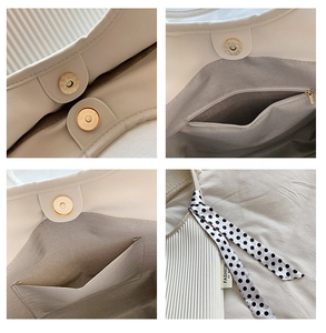 Detail of white PU leather bag featuring magnetic clasp, zip pocket and polka dot scarf