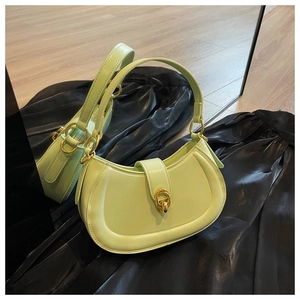 Detail of pistachio green leather crescent handbag with vintage gold metal buckle