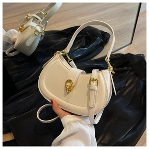 Detail of white half-moon crossbody bag with gold metallic clasp and smooth leather finish