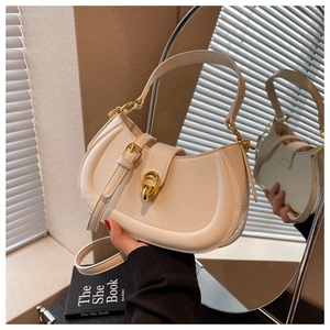 Detail of cream white half-moon bag with glossy leather and vintage gold clasp