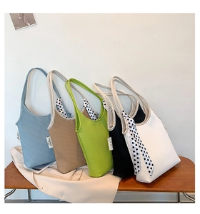 Detail of pleated shoulder bags in five colors with polka dot scarf accessories