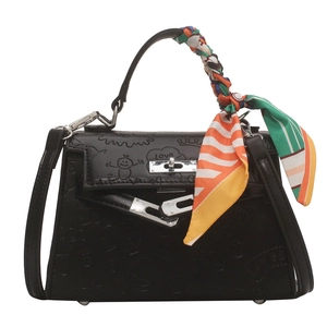 Black embossed Kelly bag with cartoon textures and decorative floral silk scarf handle