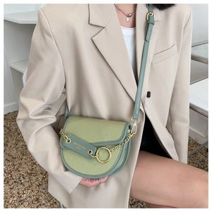 Fashionable light green crocodile pattern saddle bag with gold metal ring detail on crossbody