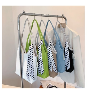 Close-up of five pleated tote bags in varied colors with decorative polka dot scarves