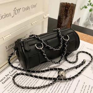 Chic black woven cylinder bag with thick chain strap and metallic ball detail