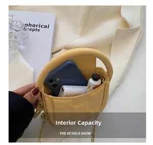 Quilted yellow mini bag interior capacity showing space for a phone and power bank