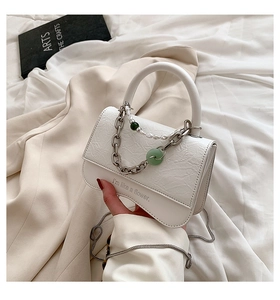 Detail of white mini crossbody bag with pleated texture and pearl chain strap
