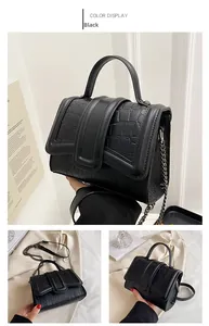 Vue détaillée d'un sac à main noir effet croco avec poignée et bandoulière en chaîne