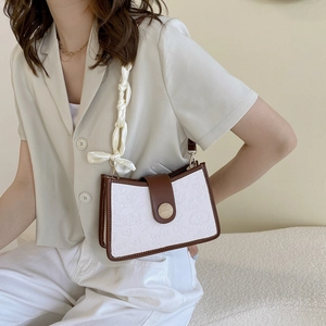 Retro shoulder bag in white textured leather with brown trim and silk scarf handle