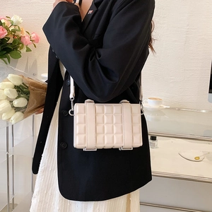 Chic beige quilted square crossbody bag with metal buckle details and long shoulder strap