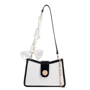 Retro style shoulder bag for women with black and white cartoon patterns and bow detail