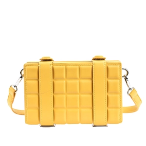 Bright yellow rectangular crossbody bag with quilted lattice texture and silver hardware