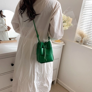 Chic green hand-woven bucket bag for women with drawstring closure and slim shoulder strap