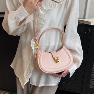 Pink crescent shoulder bag with gold hardware and top handle for modern women