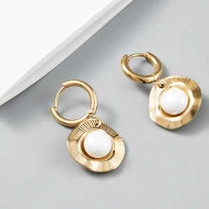 Detail of 18k gold plated stainless steel hoop earrings with pleated disc and white stone