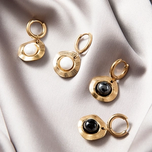 18k gold plated stainless steel hoop earrings with natural stone inlay on silk background