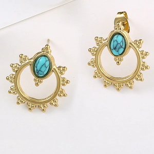 Detailed close-up of Bohemian gold stud earrings featuring oval turquoise stones