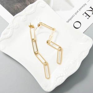 Minimalist gold stainless steel chain earrings displayed on white ceramic plate