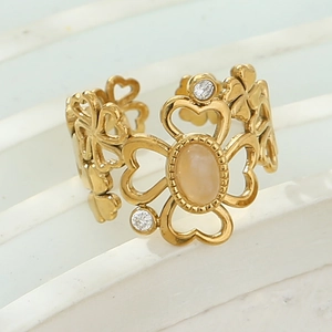 Detail of gold floral hollow ring featuring opal stone and sparkling zircon accents